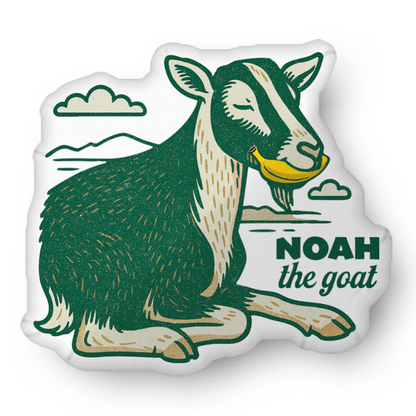 NOAH THE GOAT EATING A BANANA SHAPED PILLOW